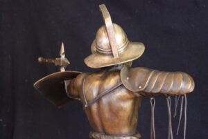 Bronze gladiator seen from back, arm raised