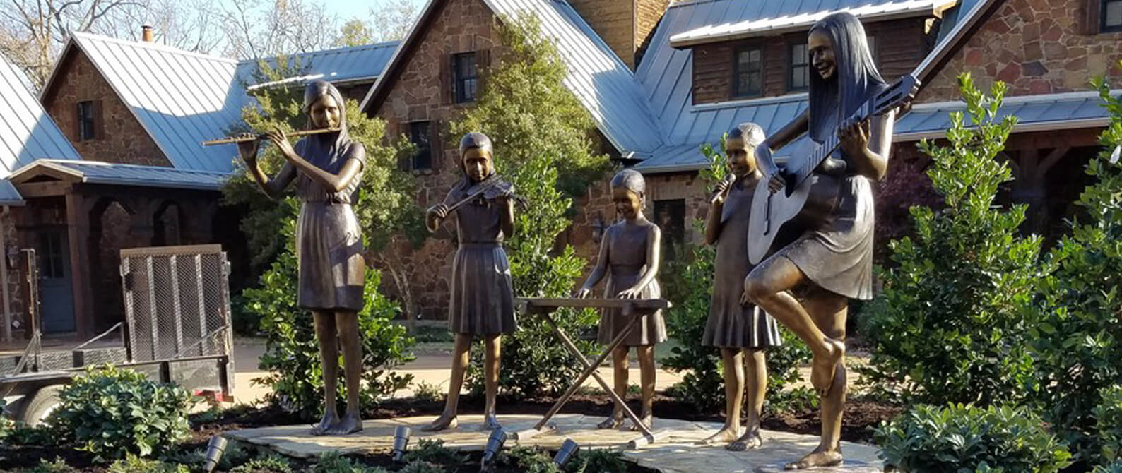 Ryan Girls Portrait Sculptures commissioned by Amanda and Brint Ryan and created in bronze by master sculptor, Tom White, for placement in at one of the Ryan residences in Texas. Daughters playing musical instruments.park statues, Reunion Park, Big Spring, Texas, family bronze sculptures, public statues, park statues, Settles Hotel Big Spring, TX, memorial bronze portraits, commission a sculpture, bronze sculptor, Tom White, girl and guitar statue