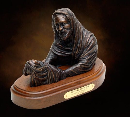 Hooded Abraham cradling wrapped baby on base