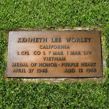 Small bronze marker set in grass