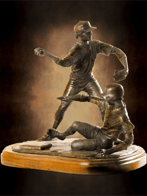 Bronze sculpture of baseball player tagging runner