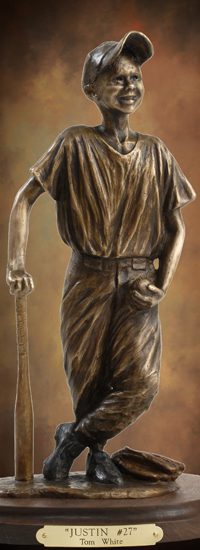 Bronze statue of smiling young baseball player