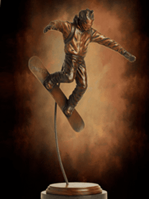 Bronze snowboarding statue performing aerial trick