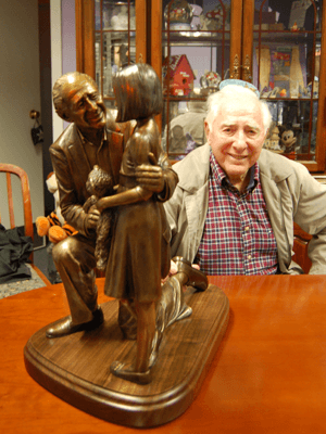 Tabletop sculpture with seated person in background