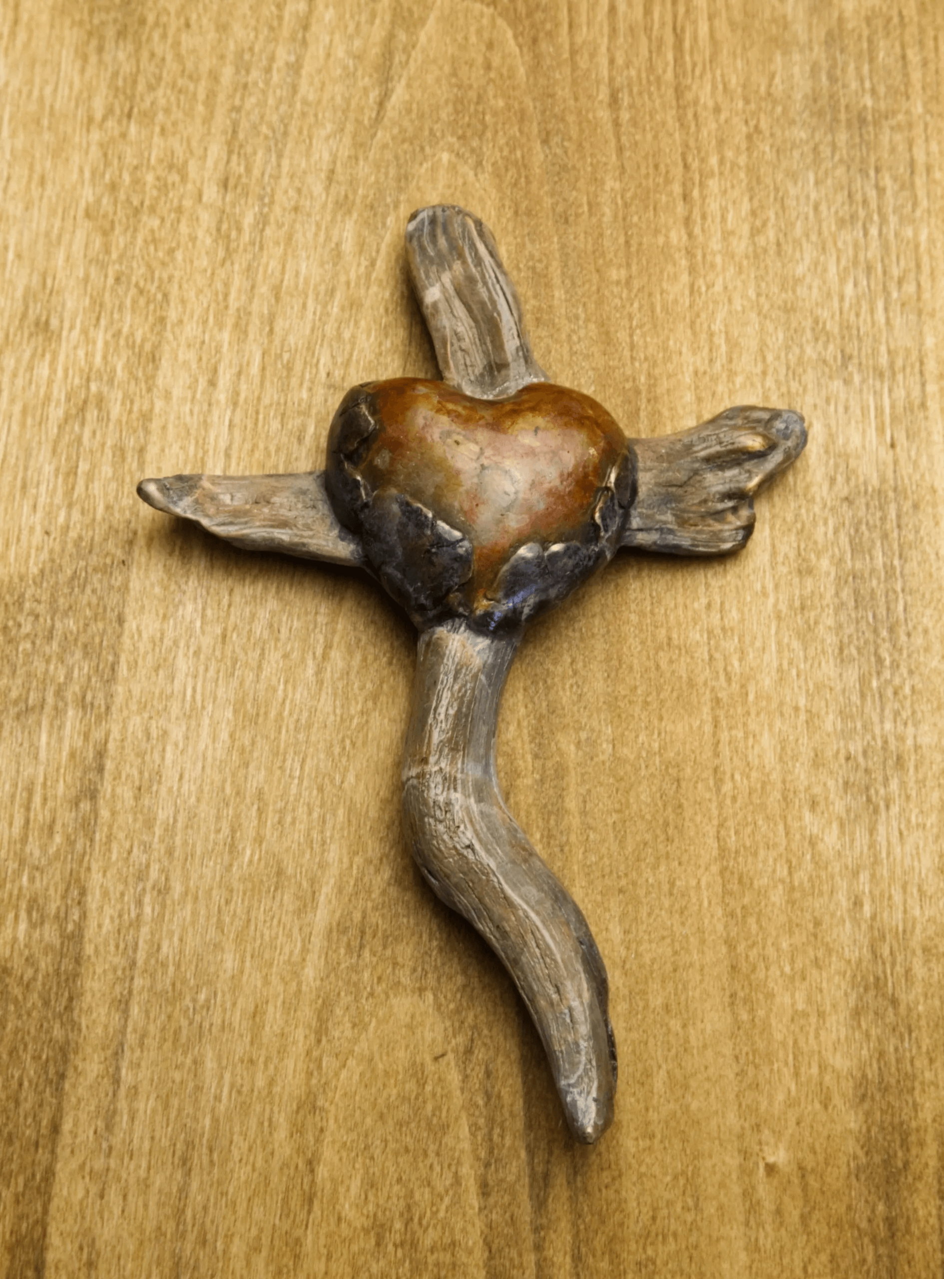 Tom White Studios, Inc | Cross Sculptures Calvary Jesus Rescued Statue Bronze heart cross on wooden background
