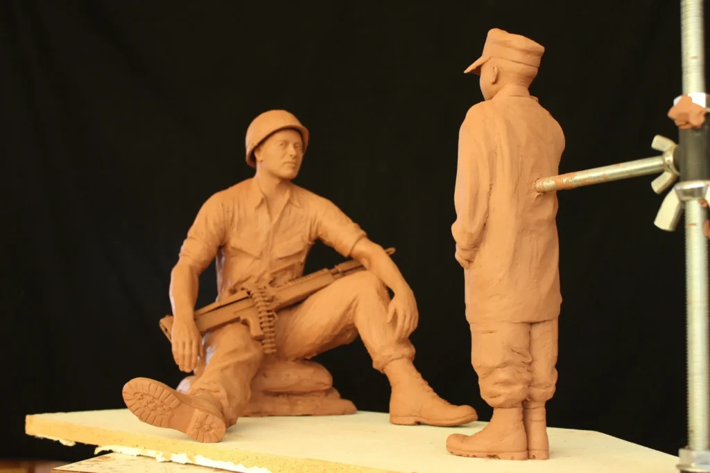 Clay maquette of seated soldier and standing figure