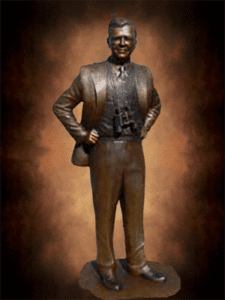 Full-length bronze figure with hands on hips