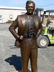 Full-length bronze statue with binoculars