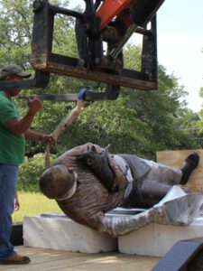 Bronze statue laid down for placement