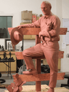 Clay maquette of rancher with hat and dog