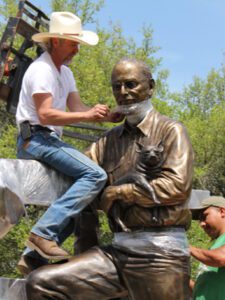 Bo Rubenstein Statue - portrait sculpture of owner of Texas Pipe for his Frebo Ranch in Columbus, Texas. Figurative memorial bronze sculptures by master Texas / Arizona commission sculptor, Tom White, monuments