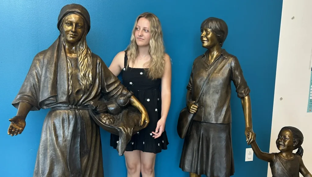 Closeup bronze sculpture trio with child