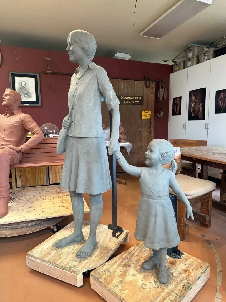 Bronze woman and little girl holding hands