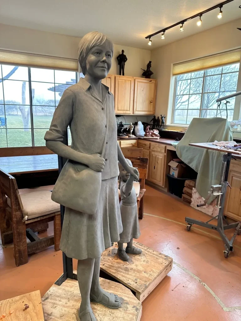 Portrait bronze woman statue carrying handbag