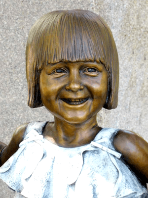 Tom White Studios, Inc | Jesus Statues Bronze girl's smiling portrait closeup